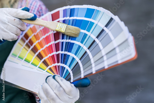 woman hand holding color palette for repair © RomanR
