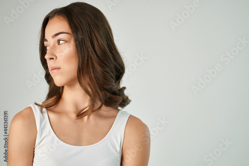attractive brunette fashion hairstyle white tank top hand gesture emotion