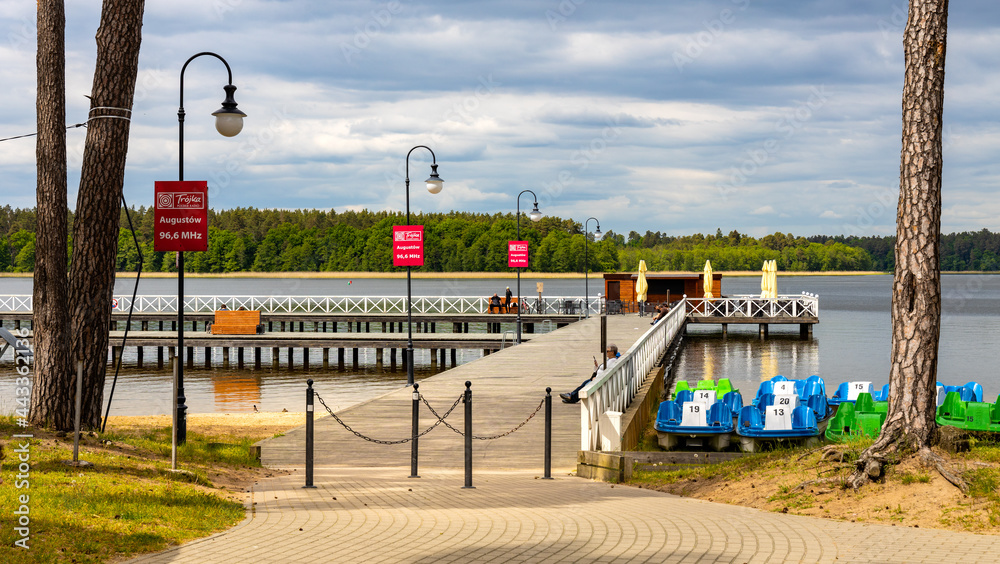Jetty pier and public beach at Necko lake shore in Masuria lake district resort town of Augustow in Podlaskie voivodship of Poland - obrazy, fototapety, plakaty 
