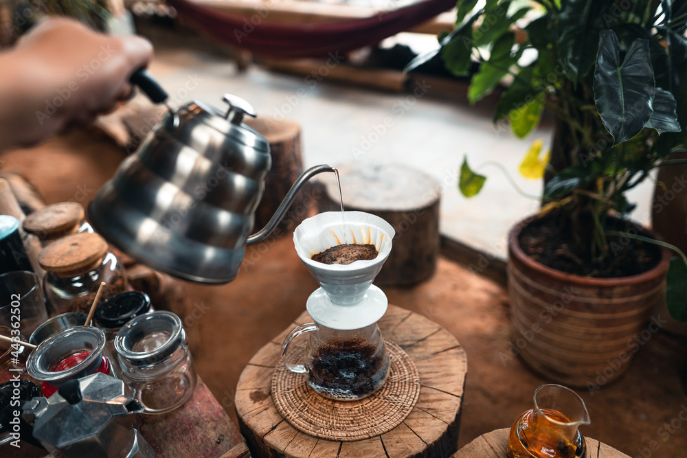 Pouring a hot water over a drip coffee Pouring a hot water over a drip coffee