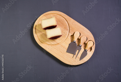 berry cheese suluguni  on wooden board grey background