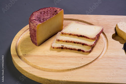 berry cheese suluguni  on  wooden board grey background