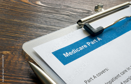 Health Insurance papers about Medicare part A and pen.