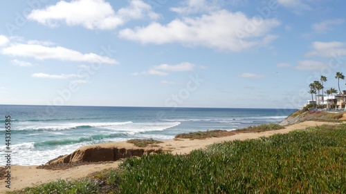 Seascape vista point, viewpoint in Carlsbad, California coast USA. Frome above panoramic ocean tide, blue sea waves, steep eroded cliff. Coastline shoreline overlook. Green ice plant succulent lawn. photo