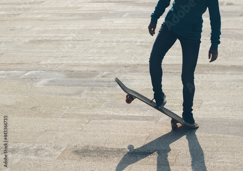 Skateboarder legs skateboarding at outdoors