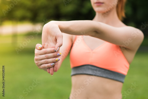 Attractive redhead woman stretching her wrist. Flexibility, recreation photo