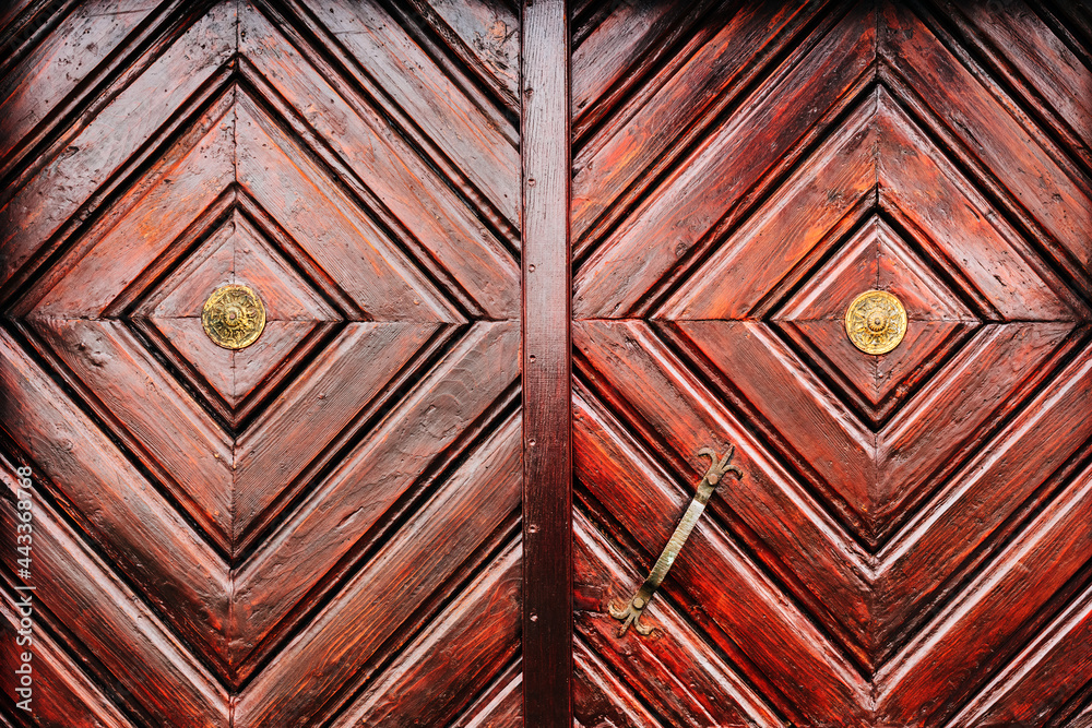 Rustic wooden door detail as background, weathered surface of massive entrance doorway - obrazy, fototapety, plakaty 