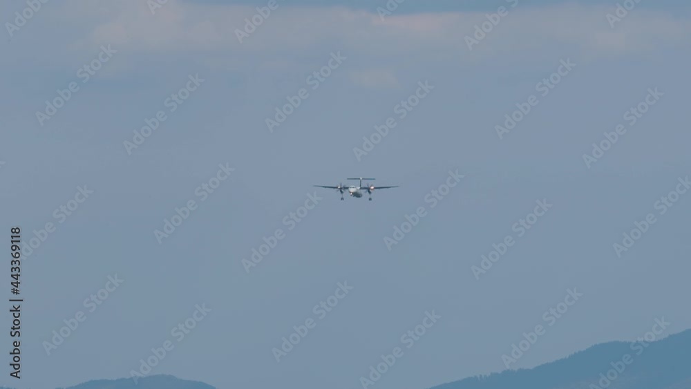 Airplane arriving at Ljubljana airport, Slovenia. Side view of aircraft landing. Slow motion view of a plane approaching Airplane arriving at Ljubljana airport, Slovenia. Side view of aircraft landing. Slow motion view of a plane approaching