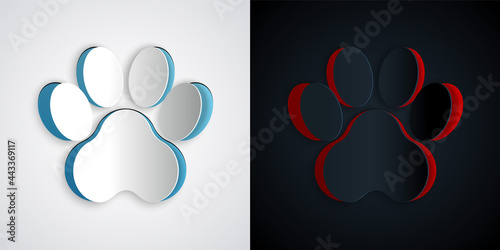 Paper cut Paw print icon isolated on grey and black background. Dog or cat paw print. Animal track. Paper art style. Vector