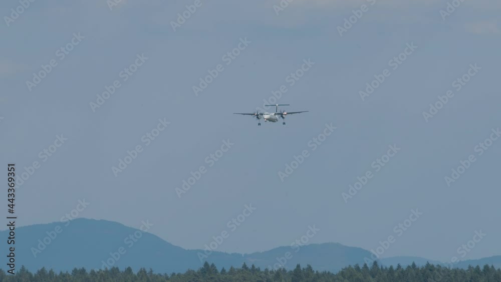 Airplane arriving at Ljubljana airport, Slovenia. Side view of aircraft landing. Slow motion view of a plane approaching Airplane arriving at Ljubljana airport, Slovenia. Side view of aircraft landing. Slow motion view of a plane approaching