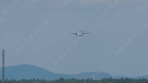Airplane arriving at Ljubljana airport, Slovenia. Side view of aircraft landing. Slow motion view of a plane approaching