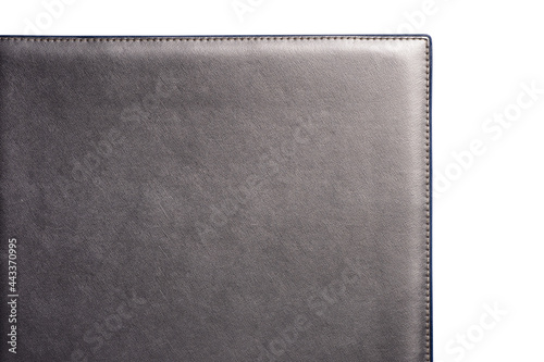 Grey fine texture of genuine leather. Close-up edge isolated at white background