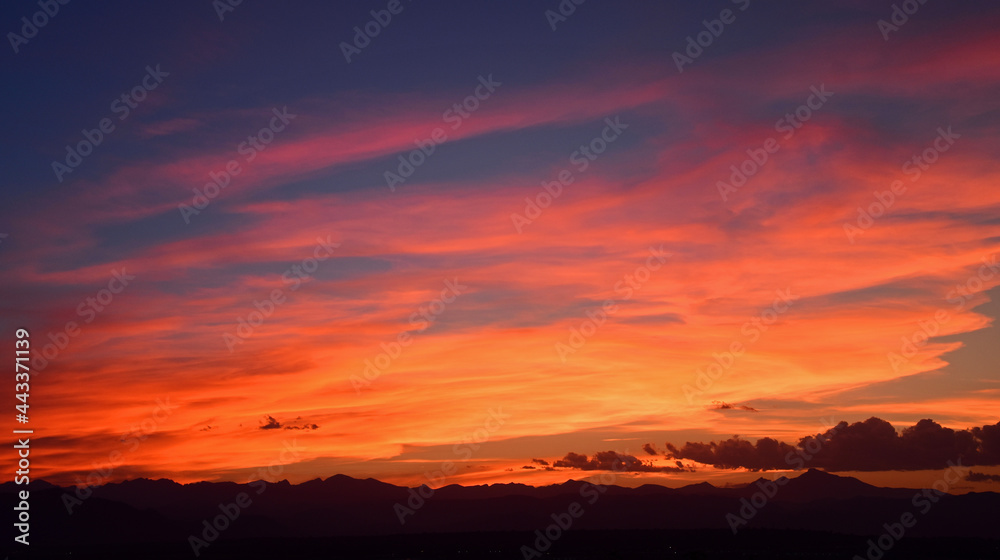 colorful sunset over long's peak and the front range of the colorado rocky mountains, as seen from broomfield, colorado 