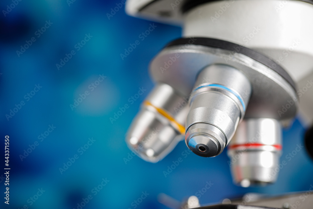 Close up shot of microscope lens and colorful blur blue background copy space Close up shot of microscope lens and colorful blur blue background copy space