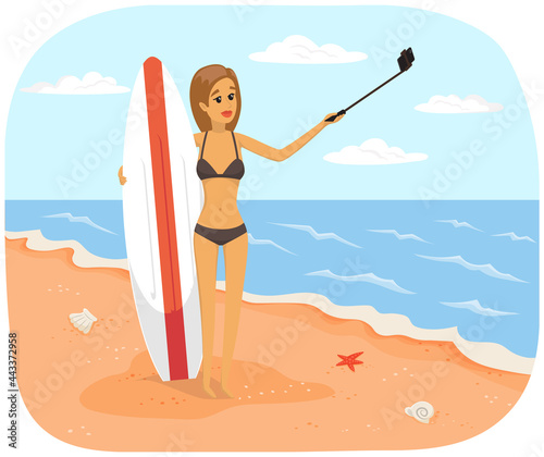 Girl is having summer vacation and surfing. Woman in swimsuit is photographed on phone camera. Lady with smartphone is posing for self portrait. Female holding surfboard is making selfie on beach