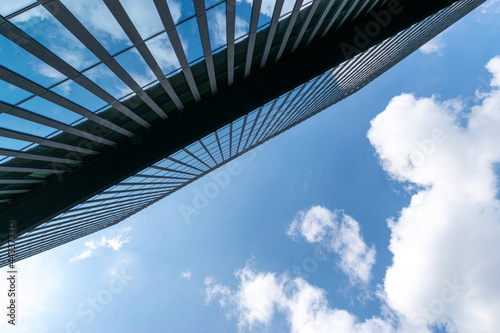 Business building. Modern office business building with glass, steel facade exterior. Finance corporate architecture city in abstract blue sky with nature cloud in sunny day.