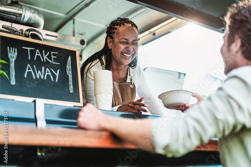 Food truck owner serving meal to male customer - Modern business and take away concept