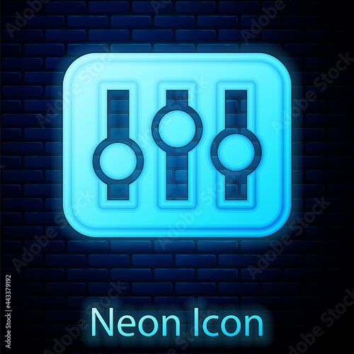 Glowing neon Sound mixer controller icon isolated on brick wall background. Dj equipment slider buttons. Mixing console. Vector