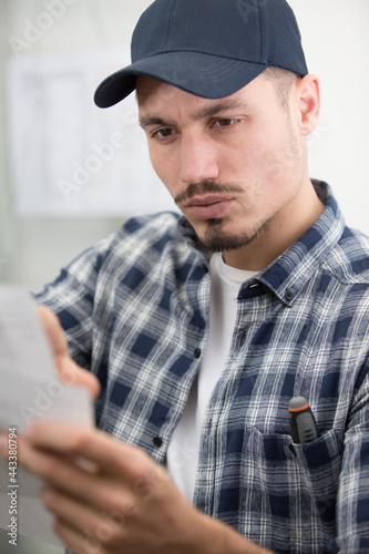 male worker reading instruction