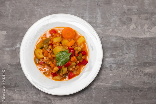 lentil with pepper, courgette and onion on white dish