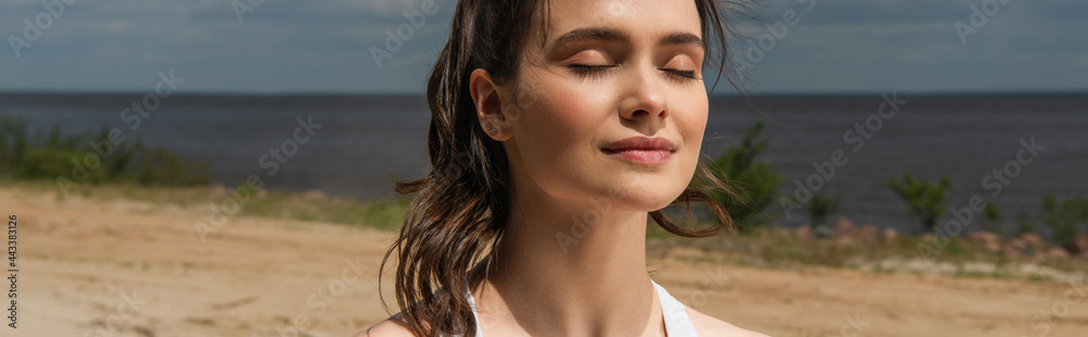 young woman with closed eyes meditating outside, banner young woman with closed eyes meditating outside, banner