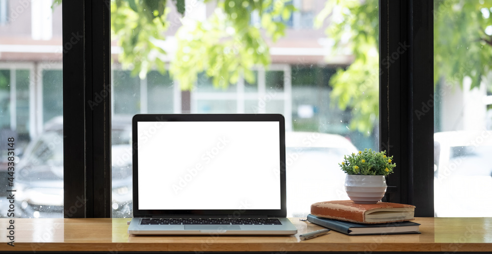 Laptop with blank screen on table of coffee cafe shop Laptop with blank screen on table of coffee cafe shop