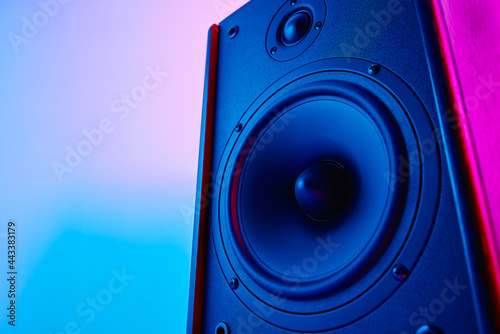 Stereo speaker on purple colored background. Sound audio loud speaker with copy space photo