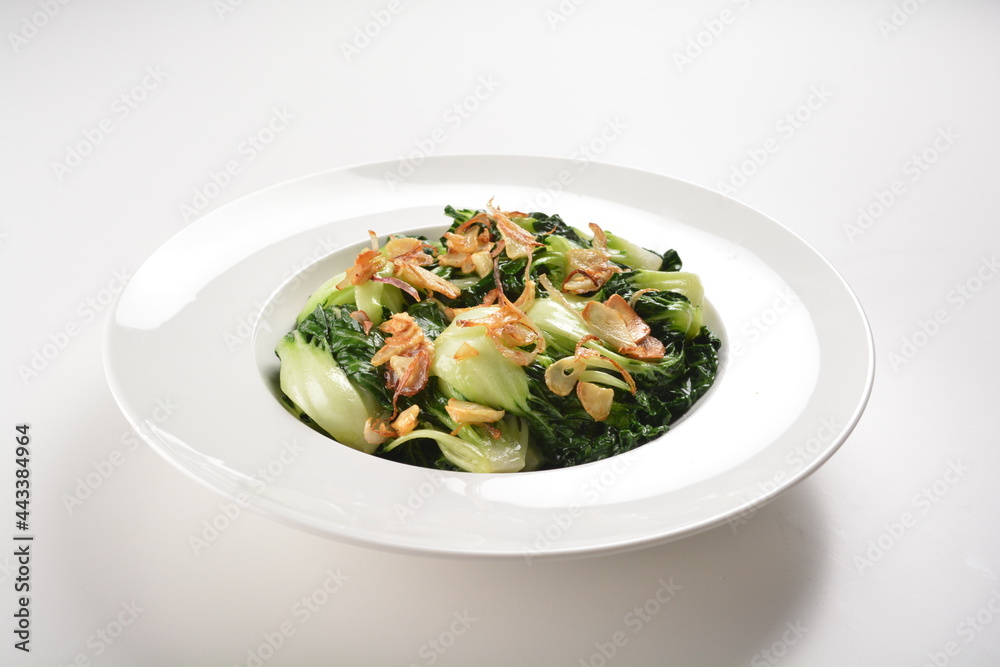 stir fried vegetable nai bai with garlic and mushroom in oyster sauce in white plate asian halal menu stir fried vegetable nai bai with garlic and mushroom in oyster sauce in white plate asian halal menu
