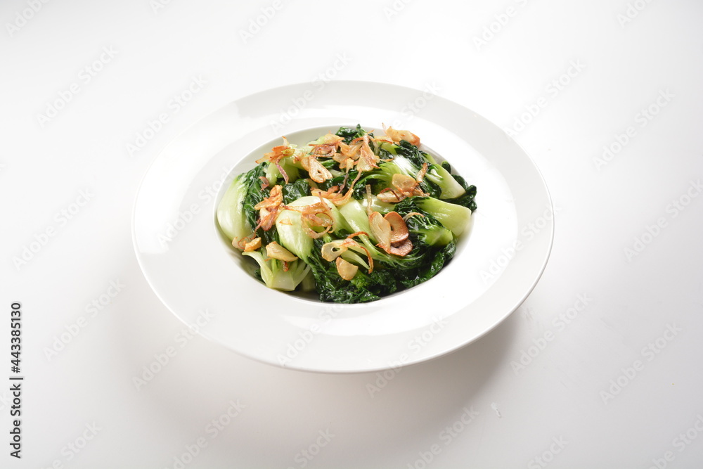 stir fried vegetable nai bai with garlic and mushroom in oyster sauce in white plate asian halal menu