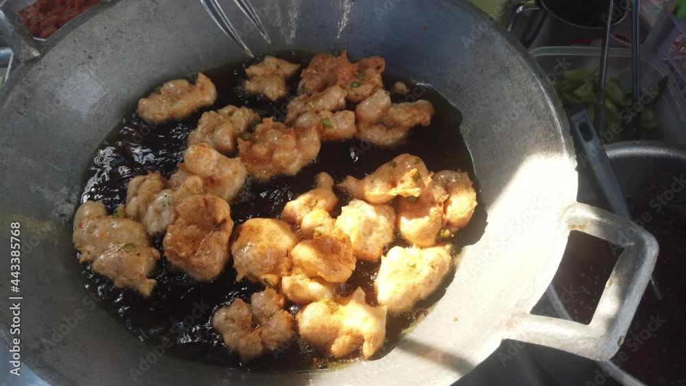 Fried fish patty in boiling oil at street food market in Thailand Fried fish patty in boiling oil at street food market in Thailand