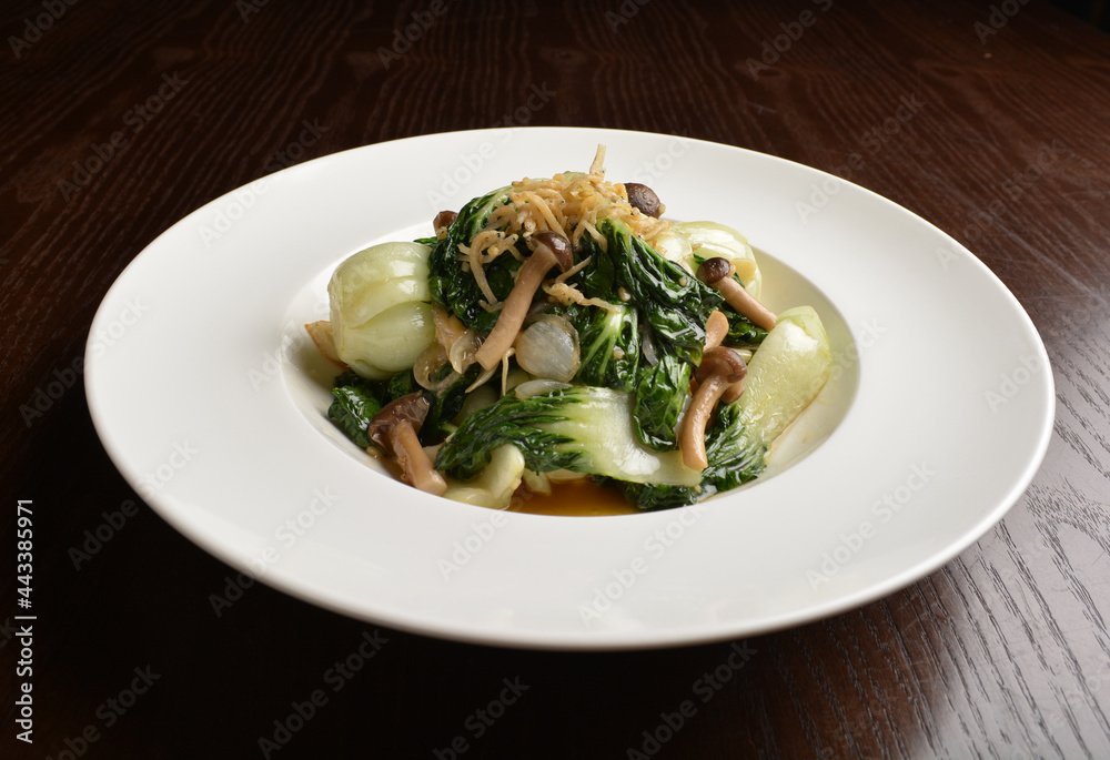 stir fried vegetable nai bai with garlic and mushroom in oyster sauce in white plate asian halal menu stir fried vegetable nai bai with garlic and mushroom in oyster sauce in white plate asian halal menu