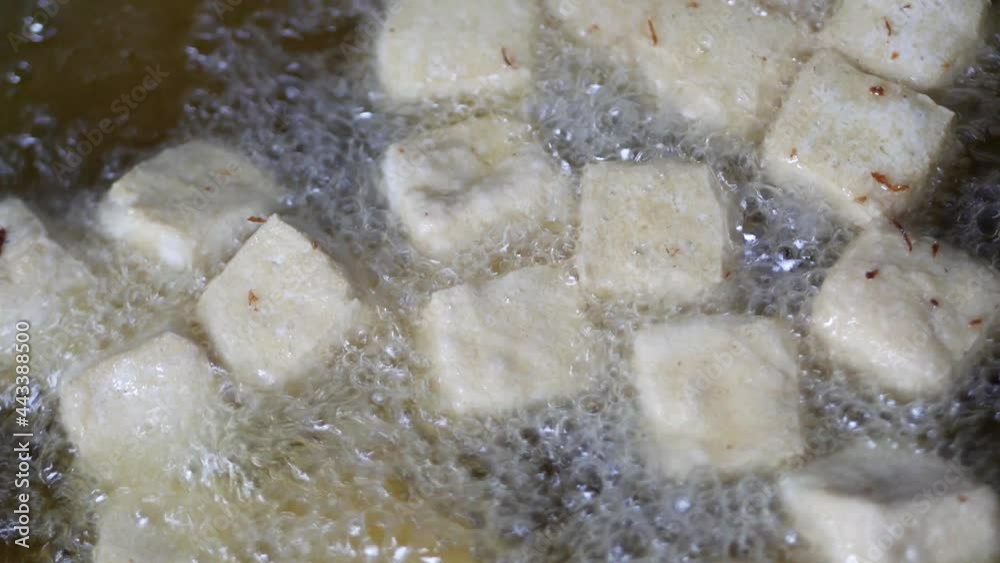 Close up deep frying tofu on wok. fring tofu cubes in wok Close up deep frying tofu on wok. fring tofu cubes in wok