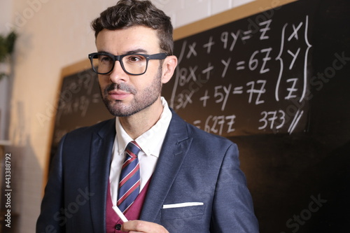 Young man in posh uniform with academic background