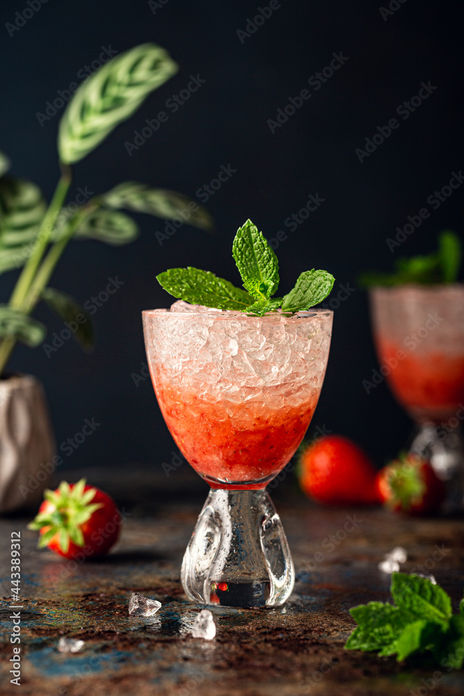 Beautiful composition with fresh cocktail with crushed ice, strawberry and mint on old rusty blue metal table. Summer cold drink concept Beautiful composition with fresh cocktail with crushed ice, strawberry and mint on old rusty blue metal table. Summer cold drink concept