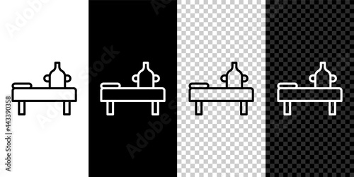 Set line Massage table with oil icon isolated on black and white background. Vector