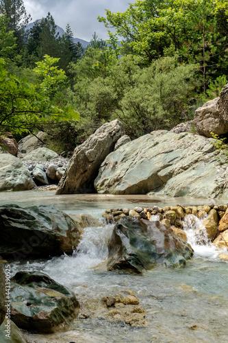 A fast mountain river flows on a overcast, summer day (Peloponnese, Greece)