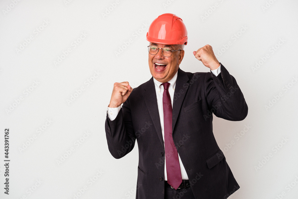 Senior american arquitech man isolated on white background raising fist after a victory, winner concept. Senior american arquitech man isolated on white background raising fist after a victory, winner concept.