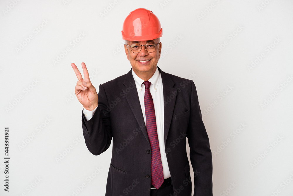 Senior american arquitech man isolated on white background joyful and carefree showing a peace symbol with fingers. Senior american arquitech man isolated on white background joyful and carefree showing a peace symbol with fingers.