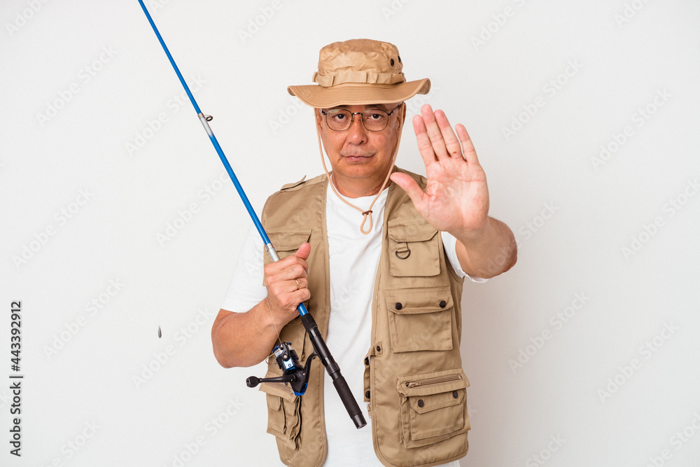 Senior american fisherman holding rod isolated on white background standing with outstretched hand showing stop sign, preventing you. Senior american fisherman holding rod isolated on white background standing with outstretched hand showing stop sign, preventing you.