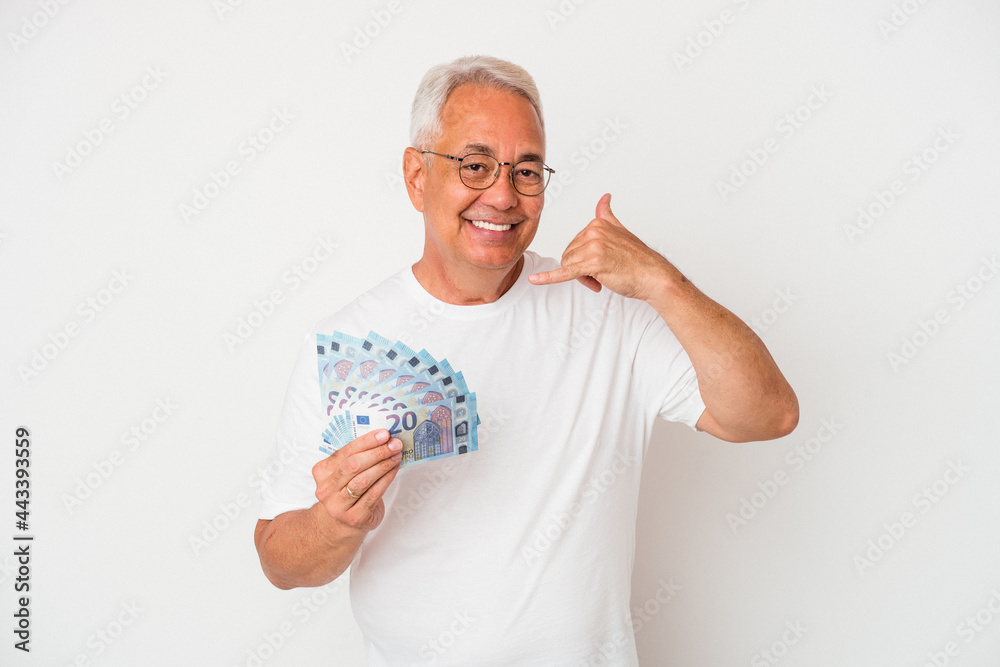 Senior american man holding bill isolated on white background showing a mobile phone call gesture with fingers.