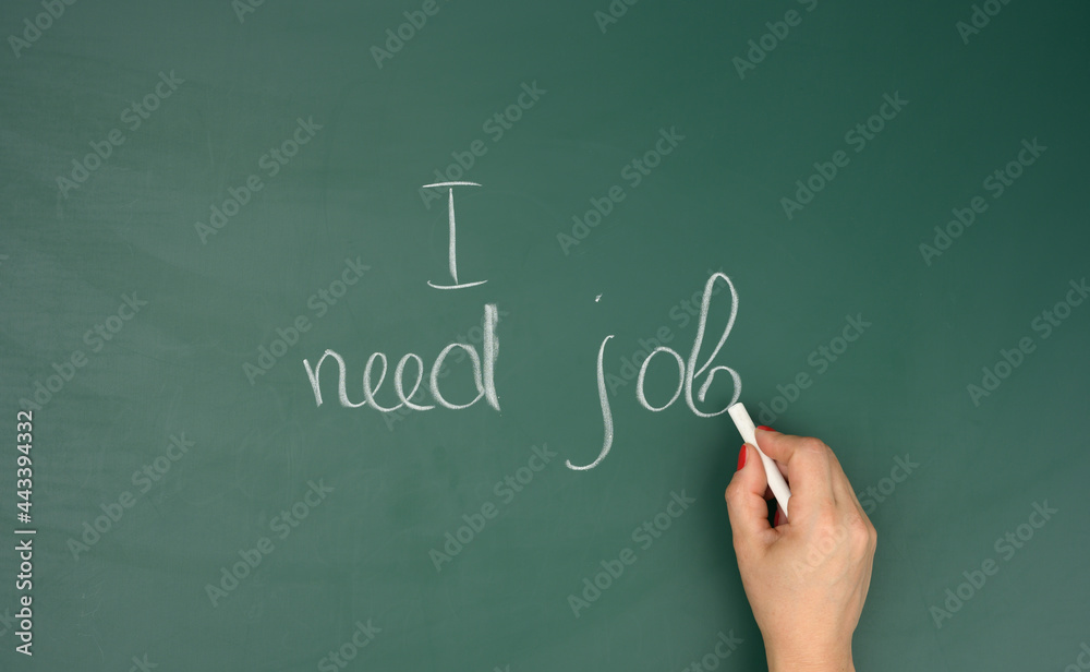 female hand wrote in white chalk I need work on a green chalk board. High unemployment concept