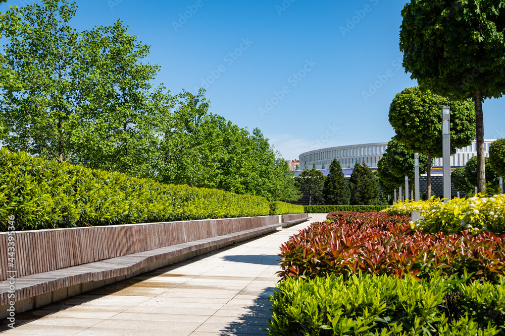 Fototapeta premium Landscape with snow-white football stadium building and French garden in foreground. Landscape city park 