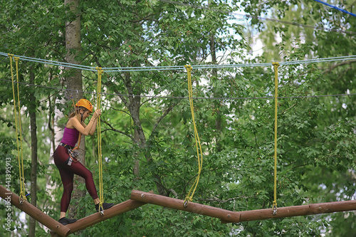 extreme vacation, girl in a yellow helmet rope park active holidays in the forest