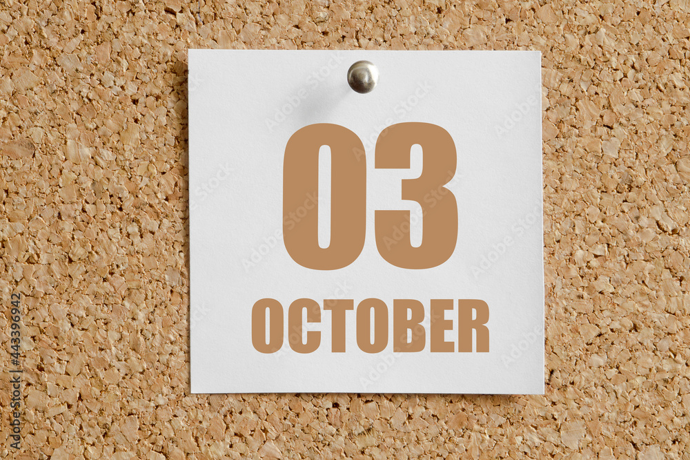 october 03. 03th day of the month, calendar date.White calendar sheet attached to brown cork board.Autumn month, day of the year concept october 03. 03th day of the month, calendar date.White calendar sheet attached to brown cork board.Autumn month, day of the year concept