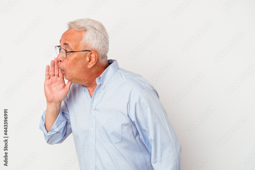 Senior american man isolated on white background is saying a secret hot braking news and looking aside Senior american man isolated on white background is saying a secret hot braking news and looking aside