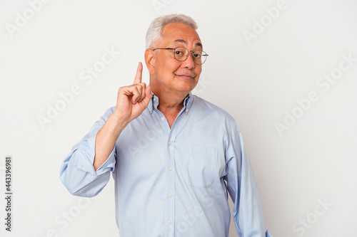 Senior american man isolated on white background showing number one with finger.