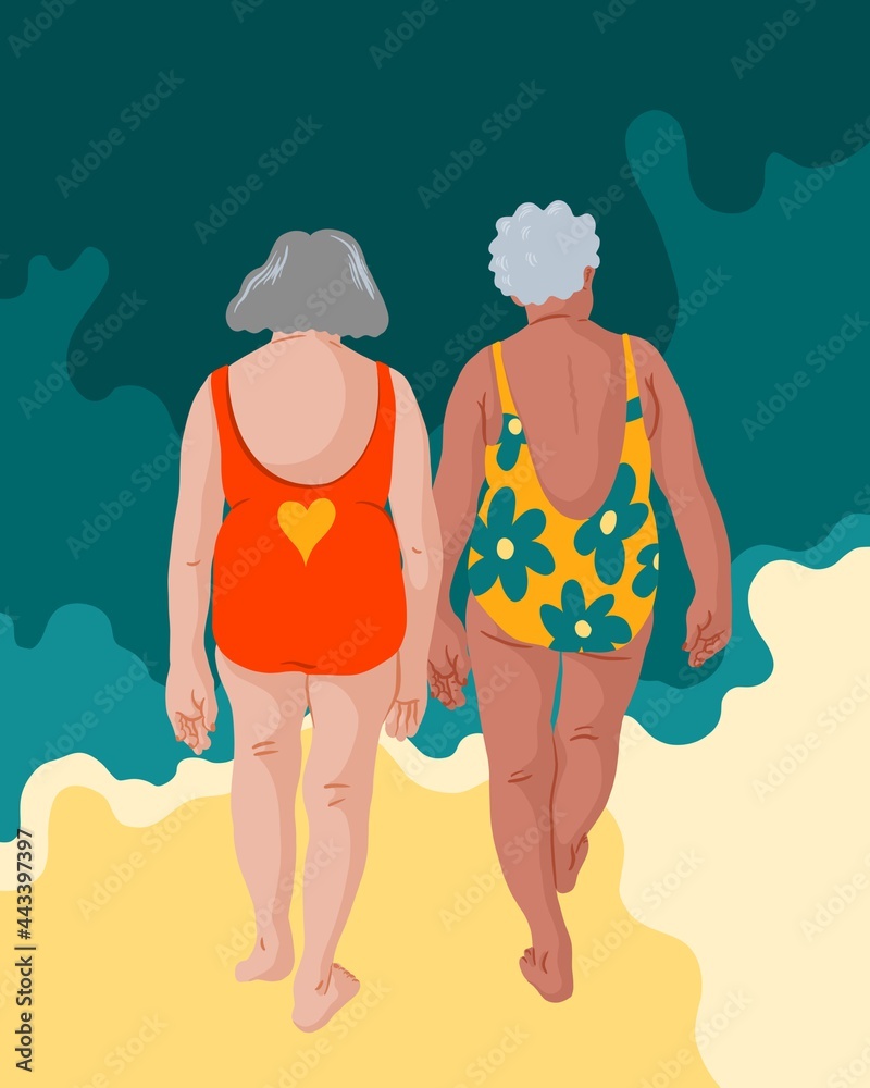Two elderly women from behind walking towards the ocean.