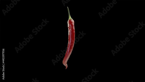 Red hot chili pepper rotating on a black background