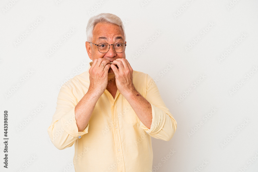 Senior american man isolated on white background biting fingernails, nervous and very anxious. Senior american man isolated on white background biting fingernails, nervous and very anxious.