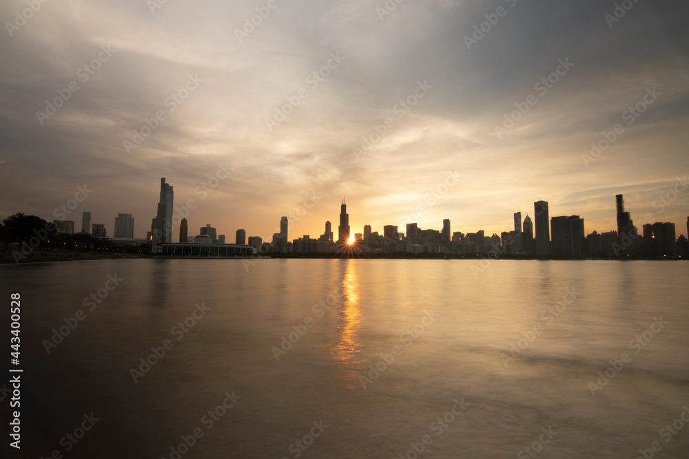 Evening Chicago Skyline with setting sun and city buildings, Chicago, USA